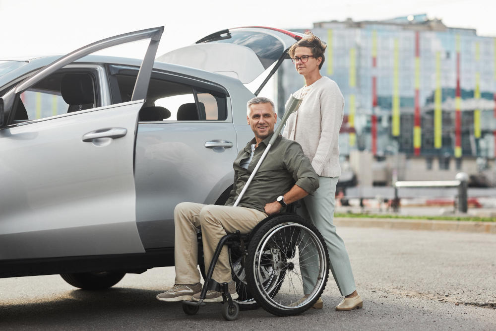 full-length-portrait-mature-couple-with-man-wheelchair-by-car-parking-lot-outdoors-copy-space
